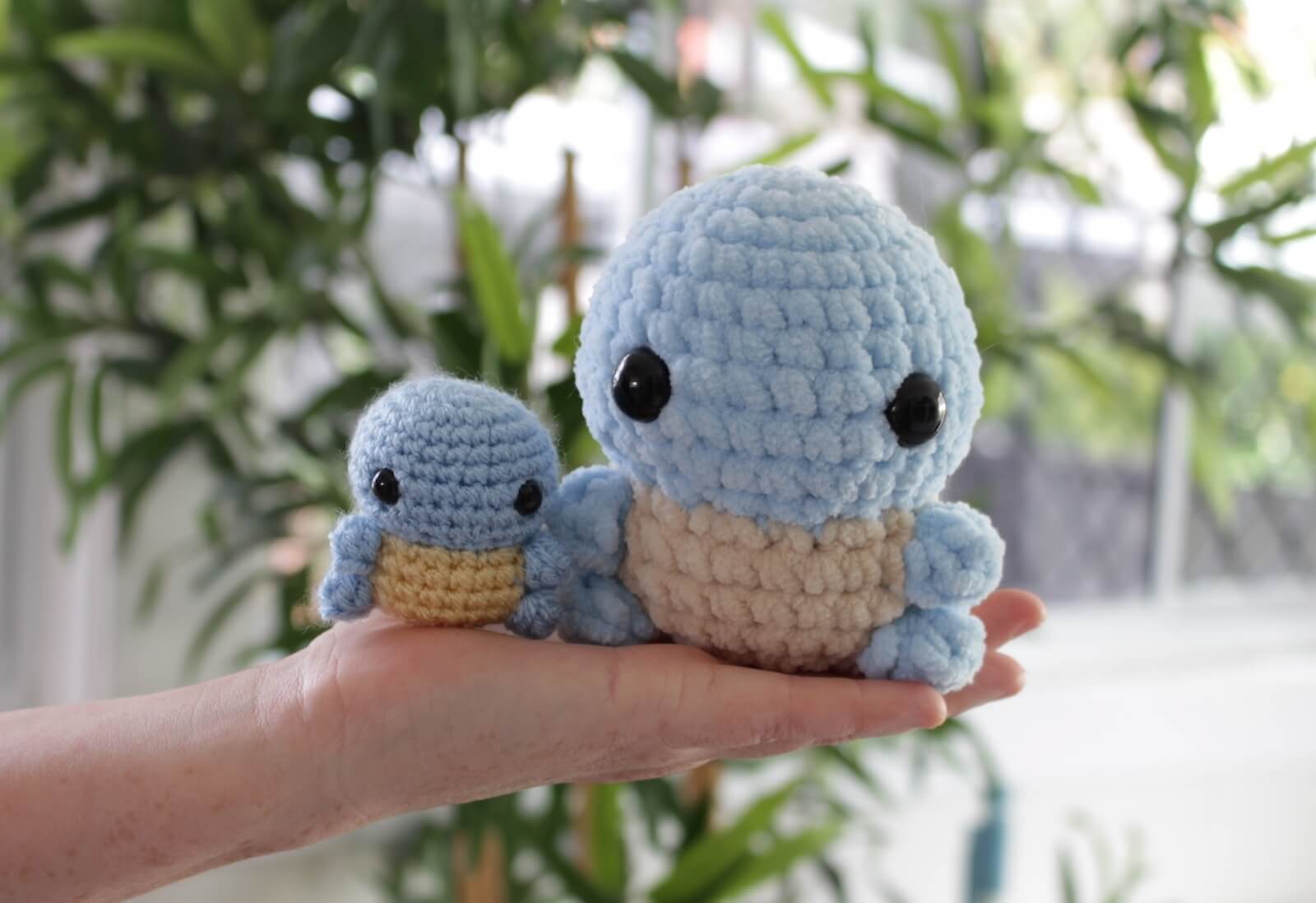 A mini low-sew squirtle made of DK yarn and a chunkier plush low-sew Squirtle made of super bulky yarn